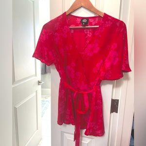 Belted peplum pink and red blouse  cinched at waist is flattering
